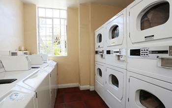 A row of washing machines in a laundromat.